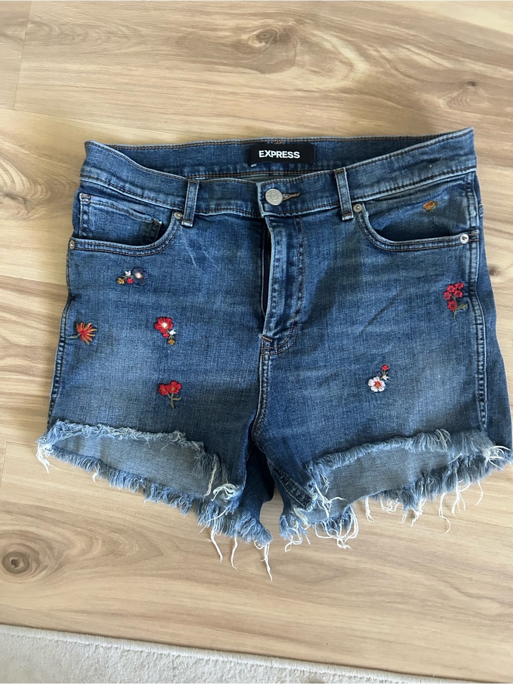Express Embroidered Blue Denim Jeans with Red and Yellow Floral Accents